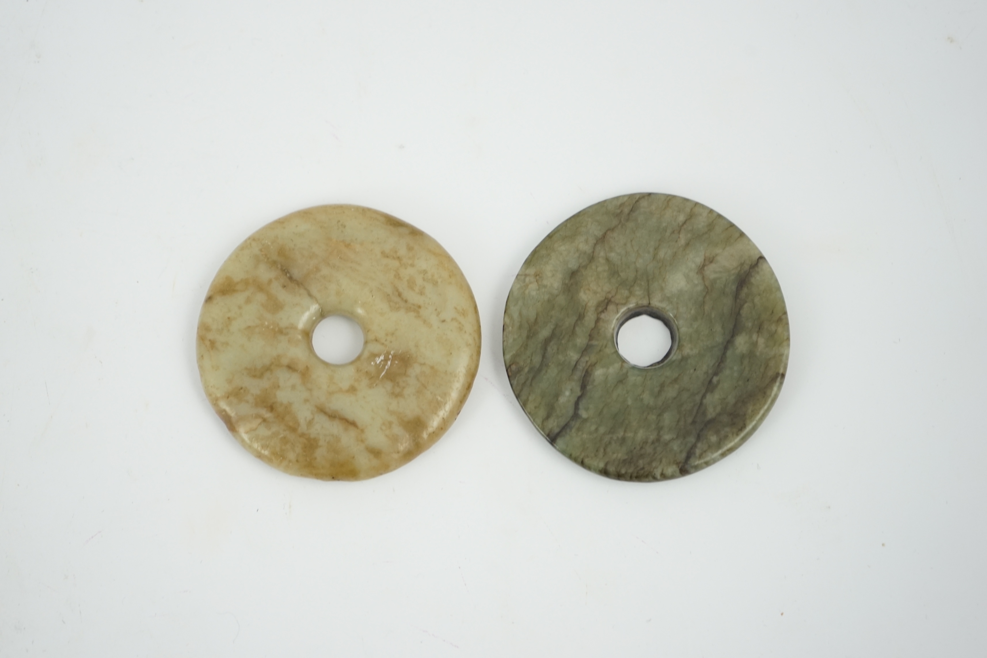 Two Chinese soapstone bi discs, and a jade ring, 18th century or earlier, largest 6.5cm in diameter. Condition - good